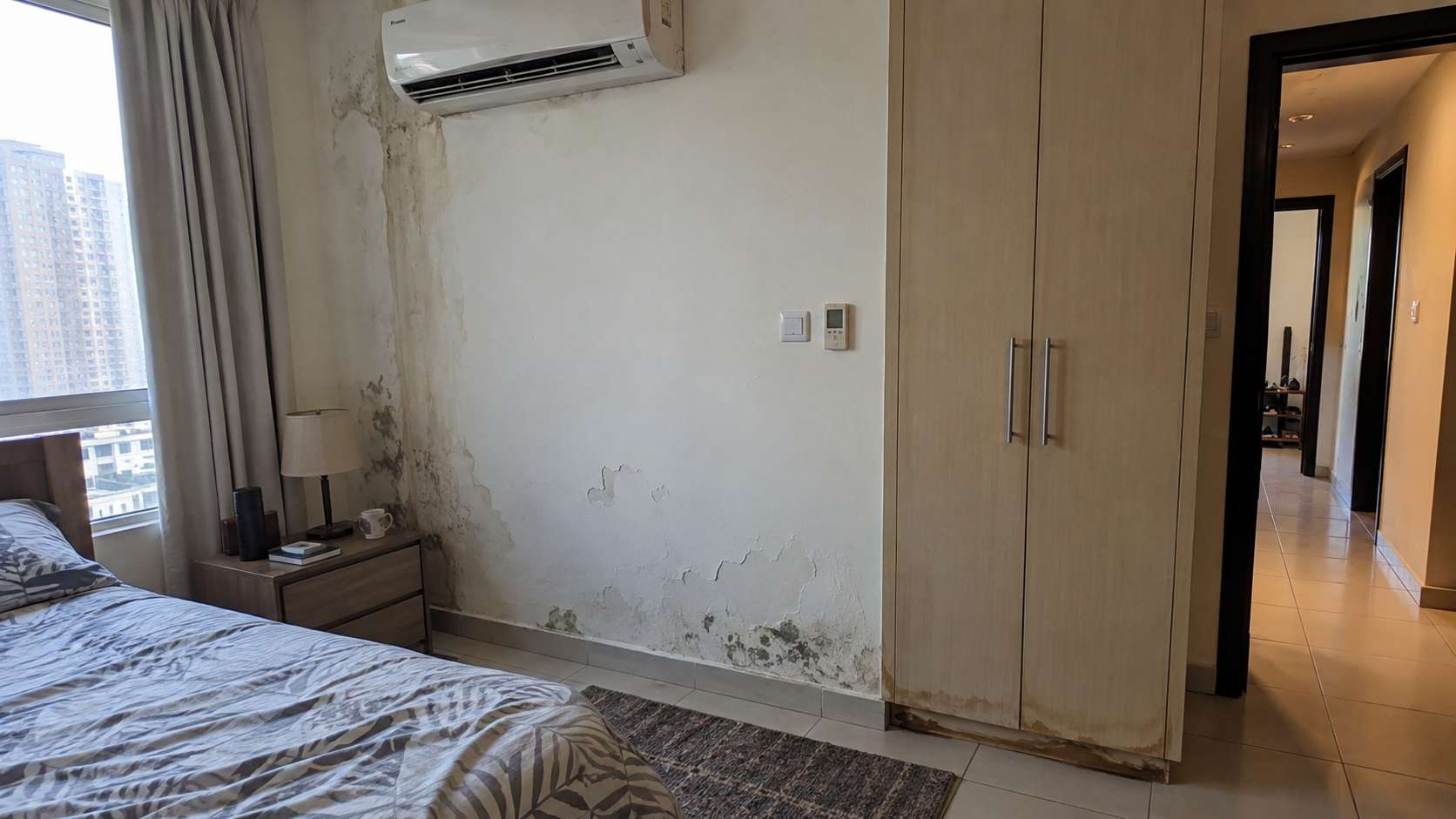 Gradual mold, peeling paint, and moisture damage developing over time in a UAE apartment