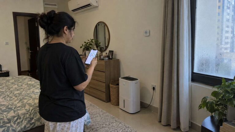 Homeowner using smart humidity sensors and a connected dehumidifier in a UAE apartment