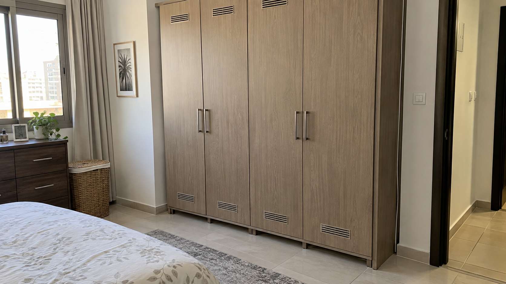 Built-in wardrobe restored with ventilation gaps and moisture-resistant detailing after mold removal in a UAE bedroom