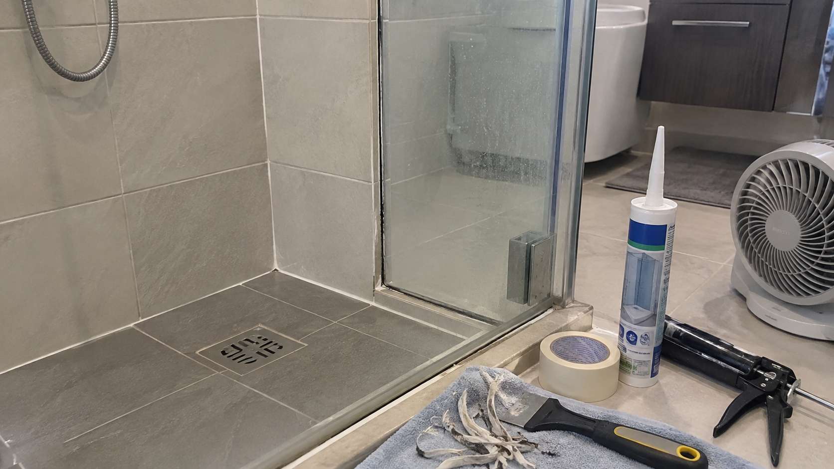 Clean dry shower joint after old moldy silicone has been removed before applying new sanitary sealant