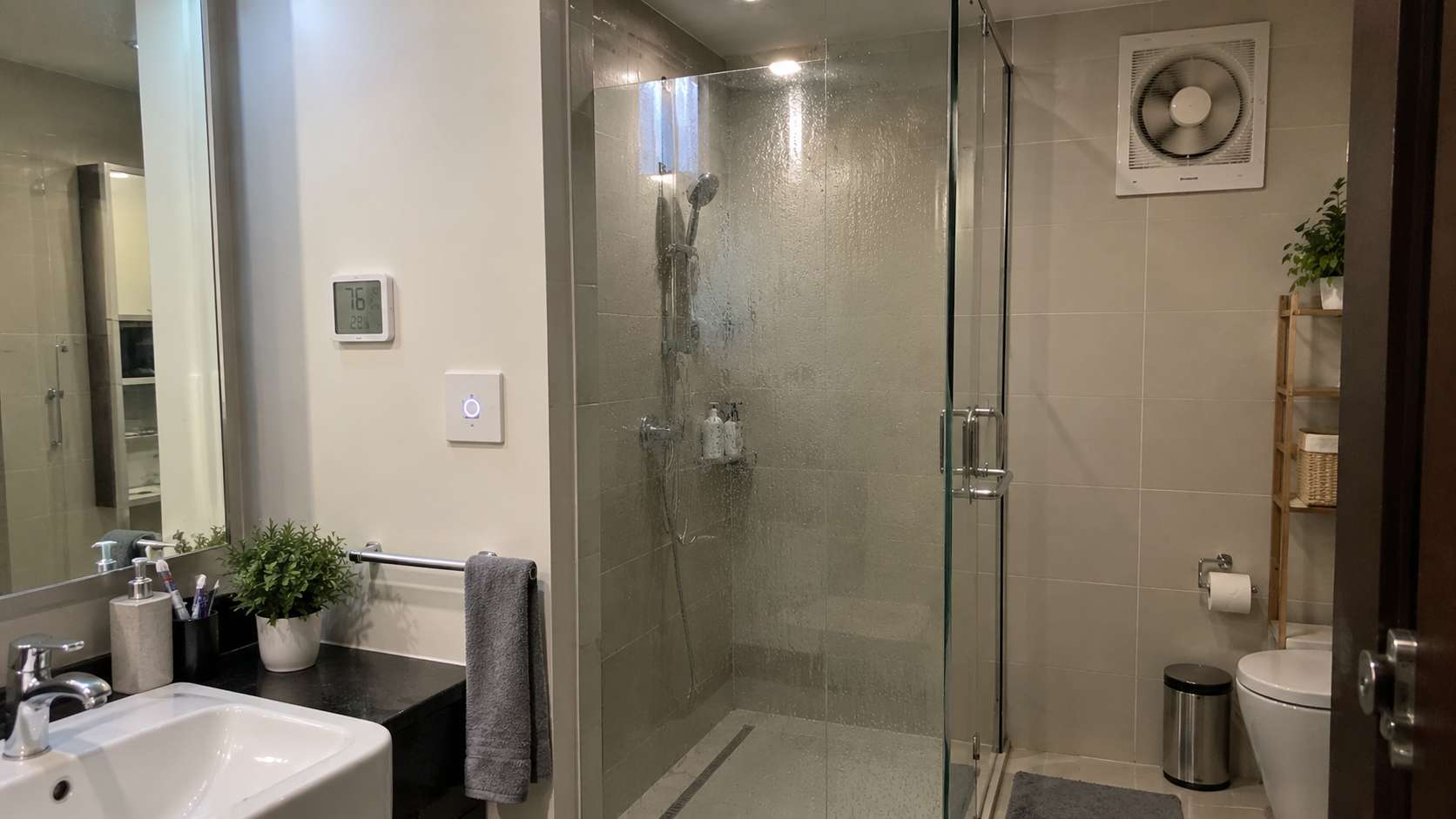 Bathroom exhaust fan automatically drying a humid shower area after use in a UAE home