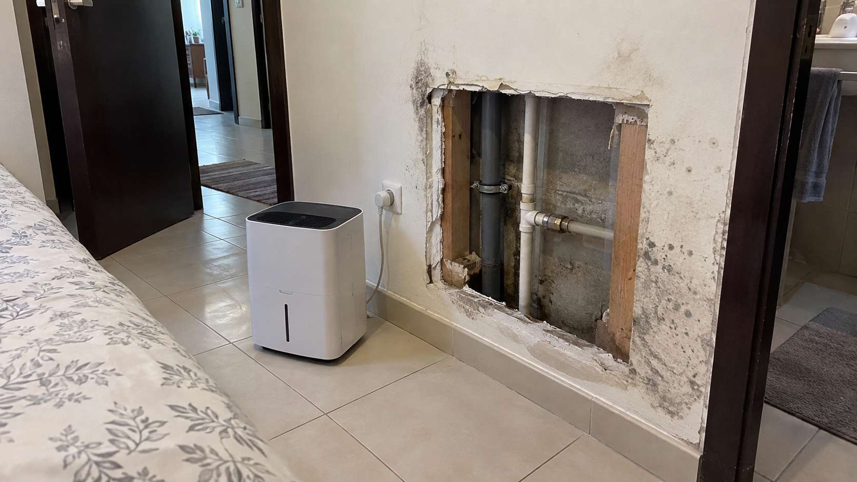 Opened wall cavity drying after leak repair and removal of mold-damaged material in a UAE home
