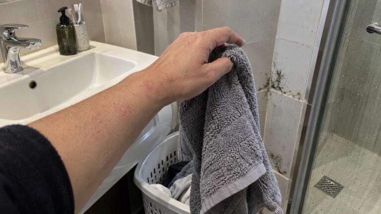 Mild skin irritation near a small mold-affected bathroom area after household mold exposure