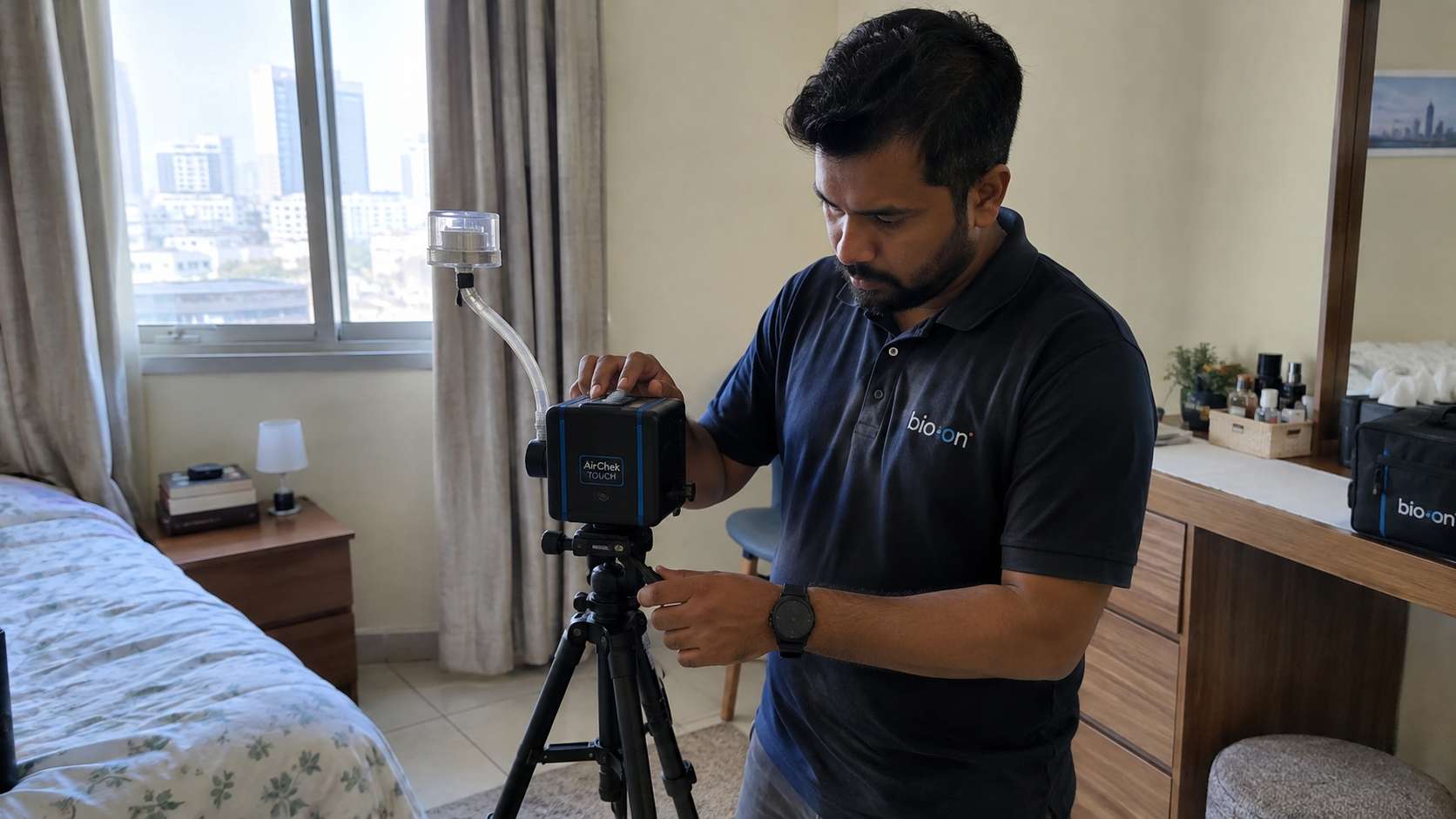 Inspector using a spore-trap cassette and air pump to collect an indoor mold air sample.