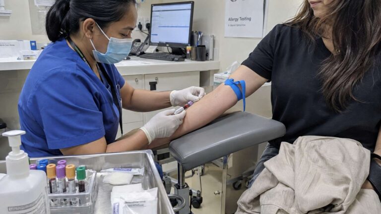 Patient having blood drawn for mold-related allergy testing in a clinic.